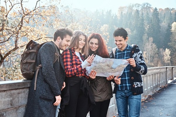 Young people are looking for right path using map 10 Must-Visit Destinations for Every Traveler in 2024