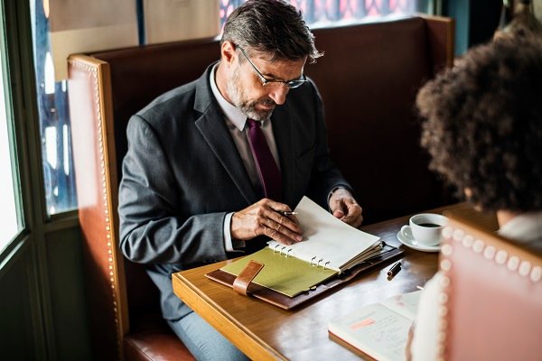 Business people discussing in the cafe How to Choose the Right Lawyer for Your Case