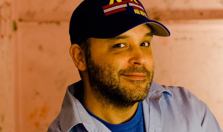 Brian Redban Net Worth showcased with a confident portrait of the comedian and podcast producer, symbolizing his career and financial journey.