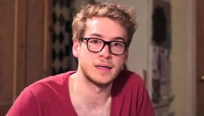 james morton net worth James Morton smiling in a kitchen, with baking tools and books in the background—symbolizing his dual success in medicine and baking, tied to James Morton net worth.